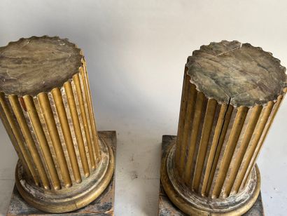 Pair of patinated and gilded oak sellettes...