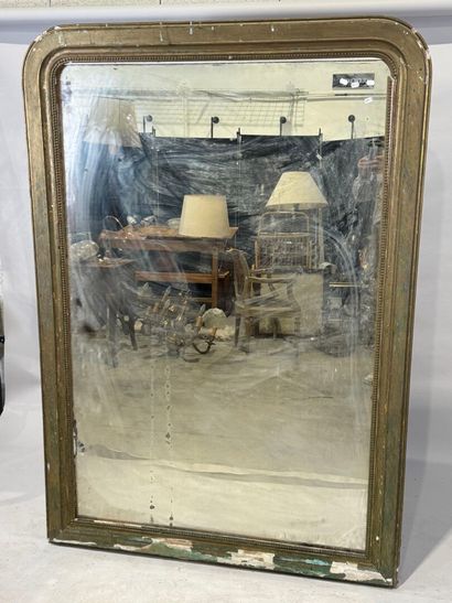 Large mirror in wood and gilded stucco decorated...