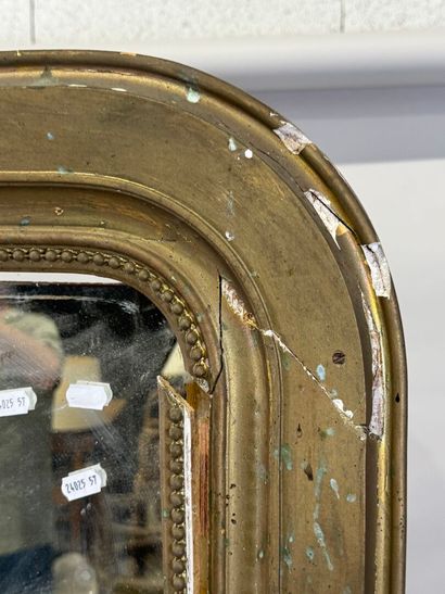 Large mirror in wood and gilded stucco decorated...