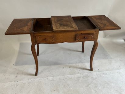 Moulded walnut dressing table, the top opening...