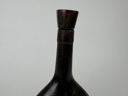 Leather-wrapped flask with small iron motif.
H....
