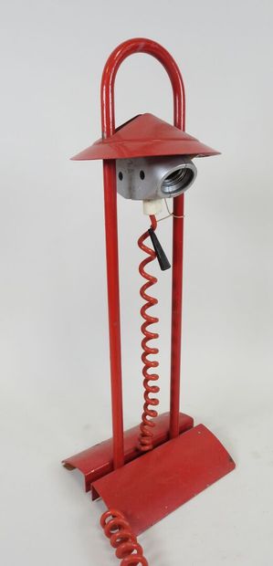 Red lacquered metal desk lamp.
Work from...