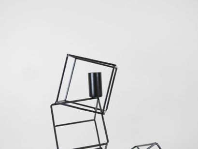 Black lacquered metal candelabra in the form...