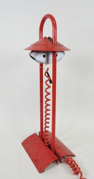Red lacquered metal desk lamp.
Work from...