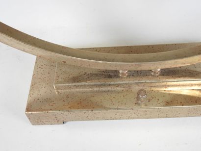 Circular chrome-plated metal lamp on a rectangular...