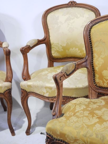 Suite of four molded and carved wood armchairs,...
