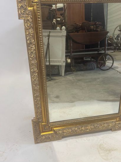Wood and gilded stucco mirror with protruding...