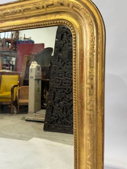 Wood and gilded stucco mirror with rounded...