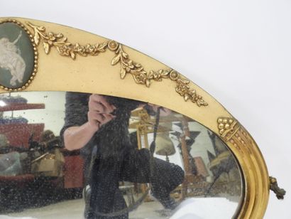 Oval-shaped bevelled mirror in wood and gilded...