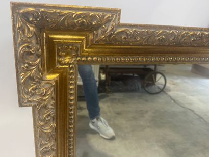 Wood and gilded stucco mirror with protruding...