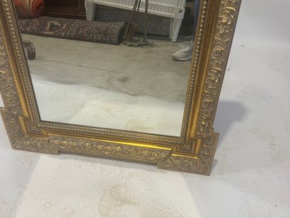 Wood and gilded stucco mirror with protruding...