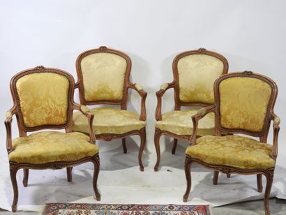 Suite of four molded and carved wood armchairs,...