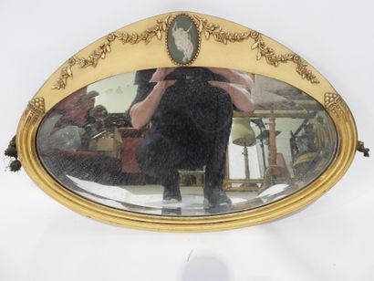 Oval-shaped bevelled mirror in wood and gilded...