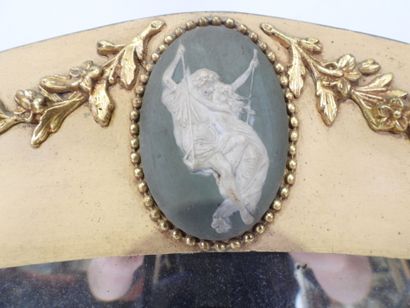 Oval-shaped bevelled mirror in wood and gilded...