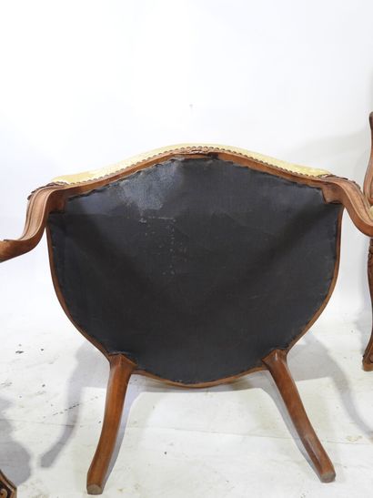 Suite of four molded and carved wood armchairs,...