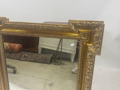 Wood and gilded stucco mirror with protruding...