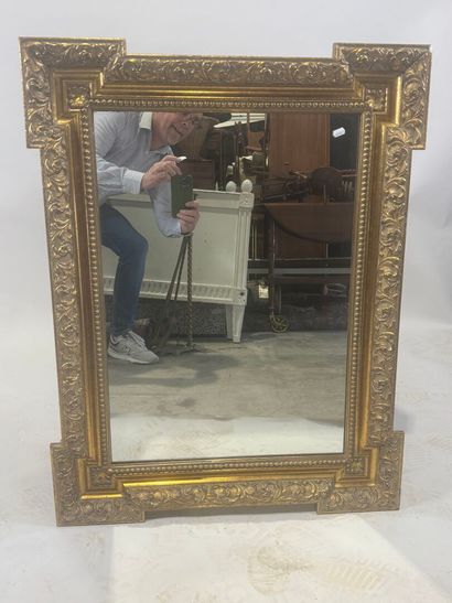 Wood and gilded stucco mirror with protruding...