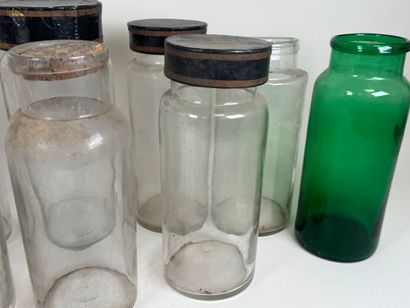 Nine glass medicine jars, one colored, with...