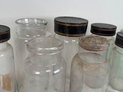 Nine glass medicine jars, one colored, with...