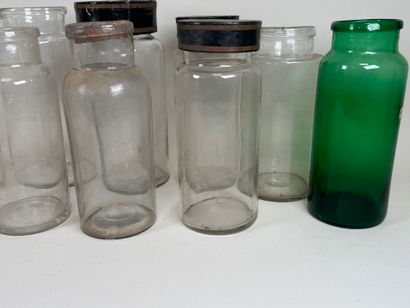 Nine glass medicine jars, one colored, with...