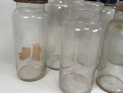 Nine glass medicine jars, one colored, with...