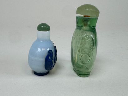 ASIA, 20th century.
Two glass snuffboxes,...