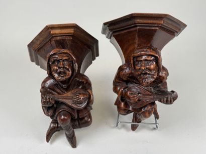 Two carved and patinated wood wall brackets...