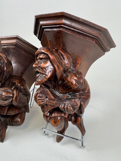 Two carved and patinated wood wall brackets...