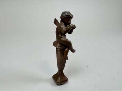 Bronze seal featuring a cherub mounted on...