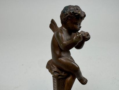 Bronze seal featuring a cherub mounted on...