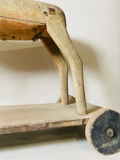 Horse on wheeled platform.
Old traces of...