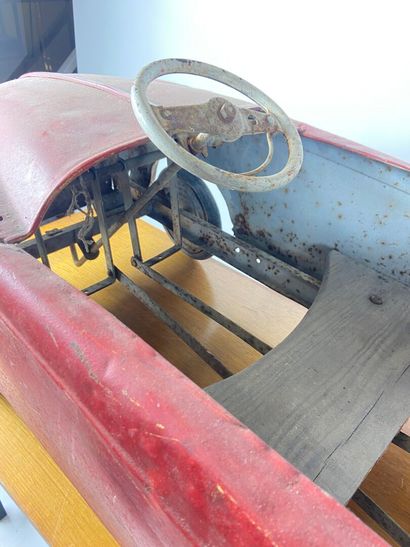 Pedal car in red painted sheet metal.
43...