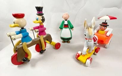 Two rolling pull-along toys:
- Donald and...
