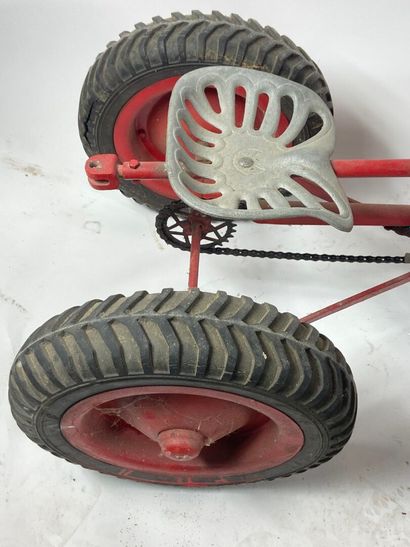 ROUCA.
Pedal tractor in red-lacquered metal,...