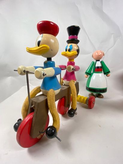 Two rolling pull-along toys:
- Donald and...