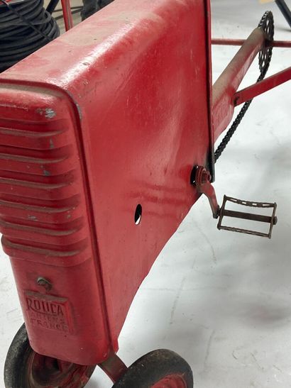 ROUCA.
Pedal tractor in red-lacquered metal,...