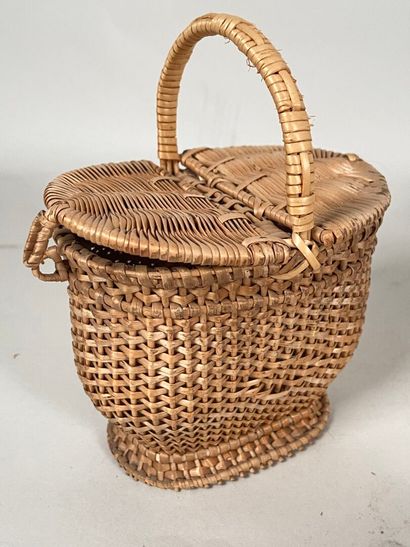 Four wicker picnic baskets with handles and...