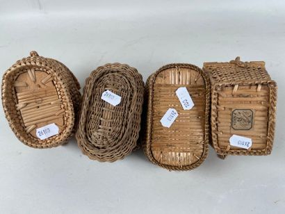 Four wicker picnic baskets with handles and...