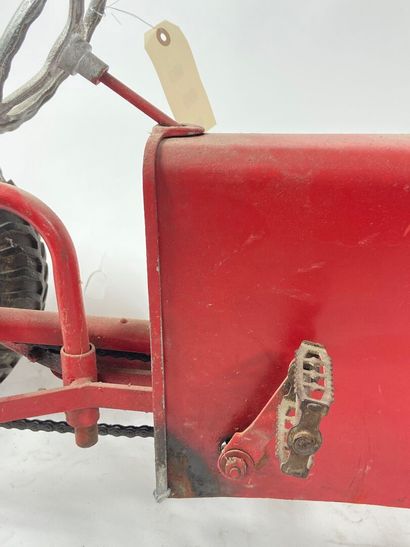 ROUCA.
Pedal tractor in red-lacquered metal,...