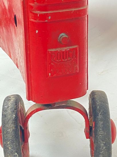 ROUCA.
Pedal tractor in red-lacquered metal,...