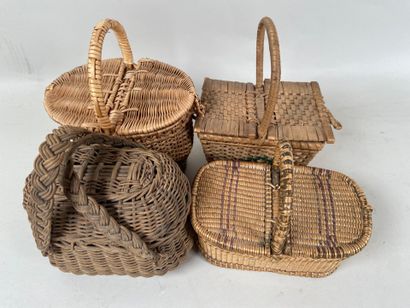 Four wicker picnic baskets with handles and...