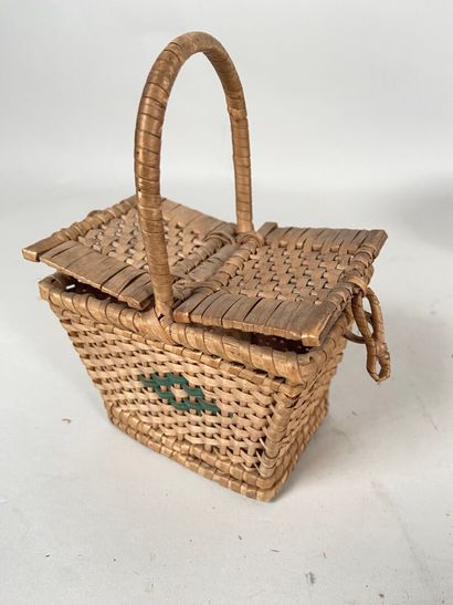 Four wicker picnic baskets with handles and...
