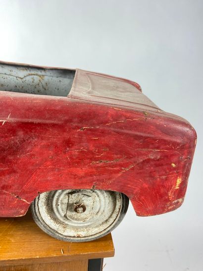 Pedal car in red painted sheet metal.
43...