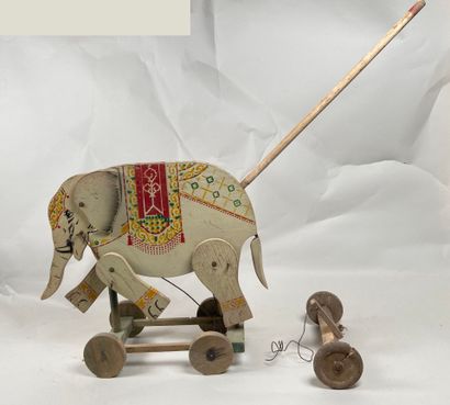 Polychrome wooden elephant on push-out wheels.
Articulation...