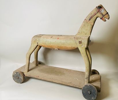 Horse on wheeled platform.
Old traces of...