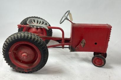 ROUCA.
Pedal tractor in red-lacquered metal,...
