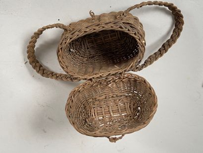 Four wicker picnic baskets with handles and...