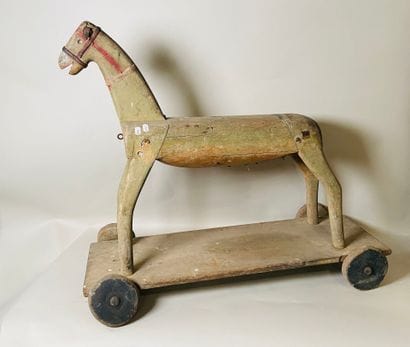 Horse on wheeled platform.
Old traces of...