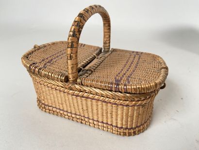 Four wicker picnic baskets with handles and...