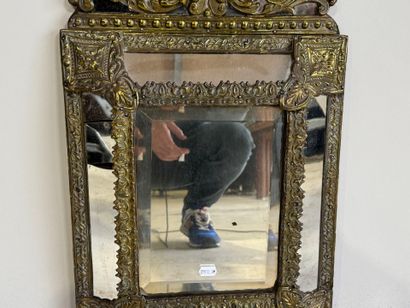 Embossed brass mirror with foliate scrolls.
58...